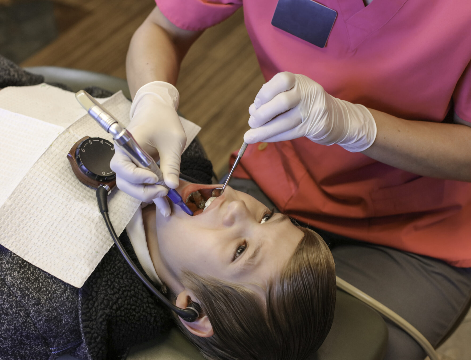 Young boy getting teeth cleaned at a dentist office.